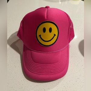 Pink smiley face trucker hat